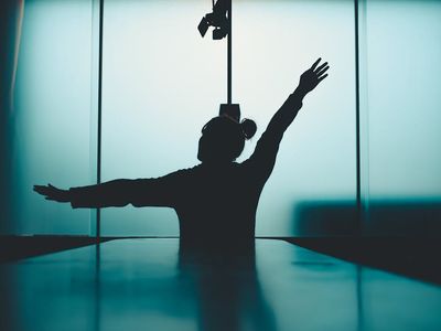 Abstract shot of a person moving through a yoga flow in shadow