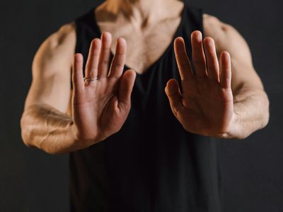 Close up of a mudra hand gesture against a black background